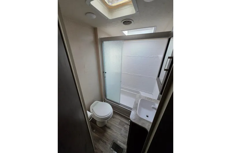 Slide: The Image of 2018 Heritage Glen 356QB RV bathroom with shower, toilet, and sink. - 17