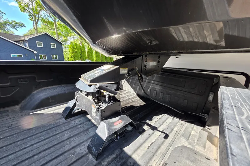 Slide: The Image of 2018 Heritage Glen 356QB fifth wheel hitch in truck bed, sunny day. - 2