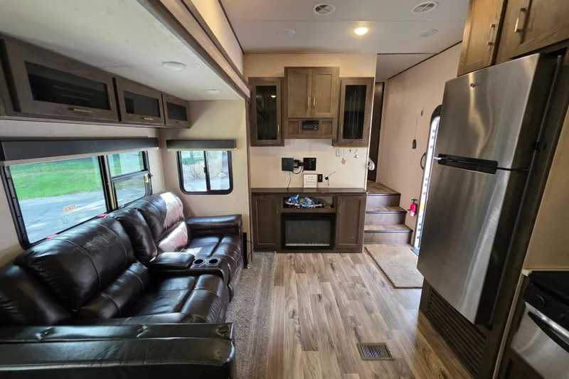 Slide: The Image of 2018 Heritage Glen 356QB interior with leather seating, modern kitchen, and wood flooring. - 20