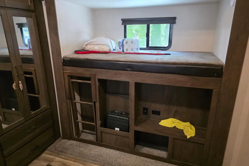 Slide: The Image of 2018 Heritage Glen 356QB RV interior with bunk bed, storage, and window. - 21