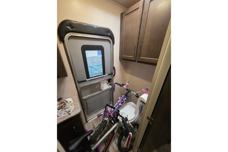 Slide: The Image of 2018 Heritage Glen 356QB interior with bicycle in compact bathroom space. - 26