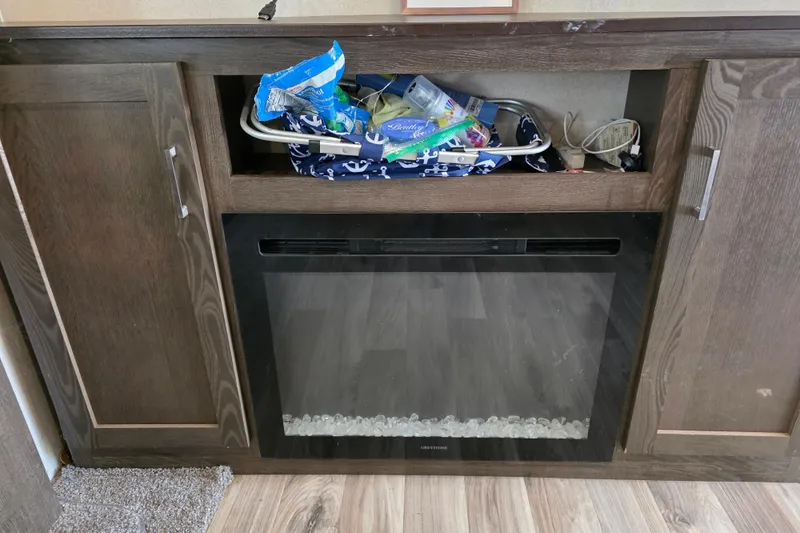 Slide: The Image of 2018 Heritage Glen 356QB interior with fireplace and storage cabinet. - 28