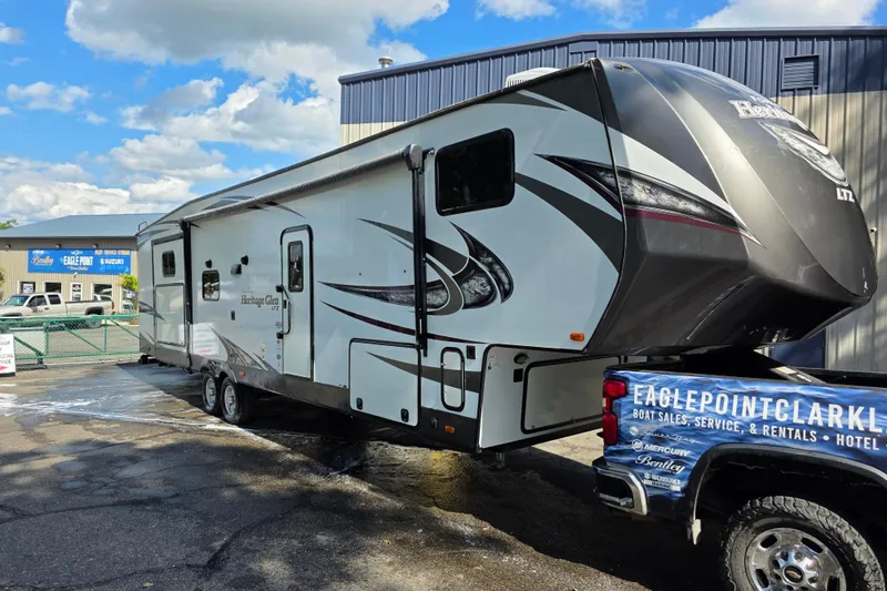 Slide: The Image of 2018 Heritage Glen 356QB RV parked outside dealership under blue sky. - 3