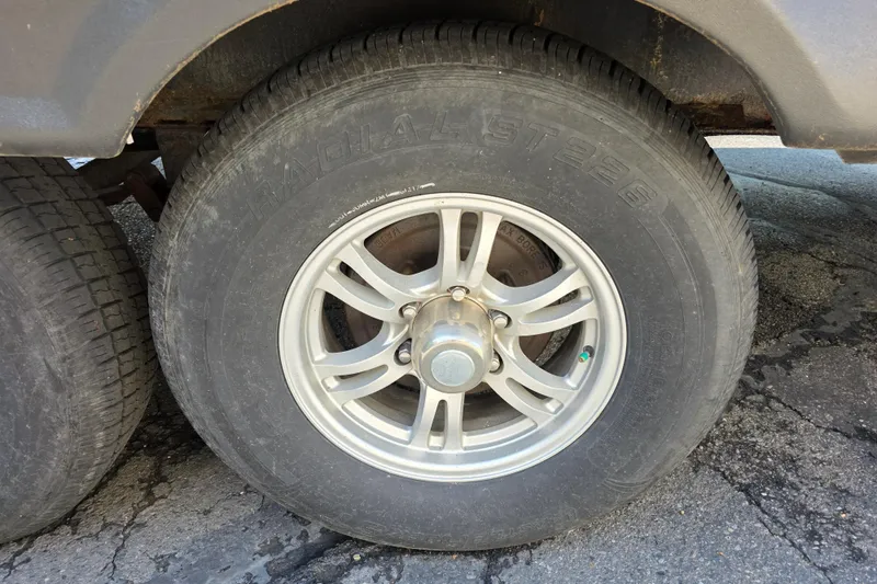 Slide: The Image of 2018 Heritage Glen 356QB wheel with radial tire on asphalt surface. - 32