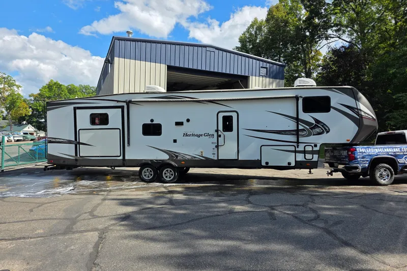 Slide: The Image of 2018 Heritage Glen 356QB RV parked outdoors near a building on a sunny day. - 4