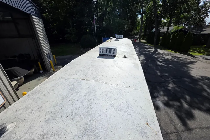 Slide: The Image of Roof of 2018 Heritage Glen 356QB RV with vents, parked near trees and a building. - 6