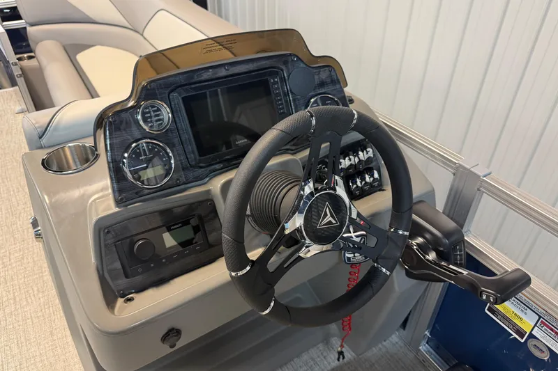 Slide: The Image of 2026 Tahoe Pontoon Sport 85 Rear Fish dashboard with steering wheel and controls. - 5