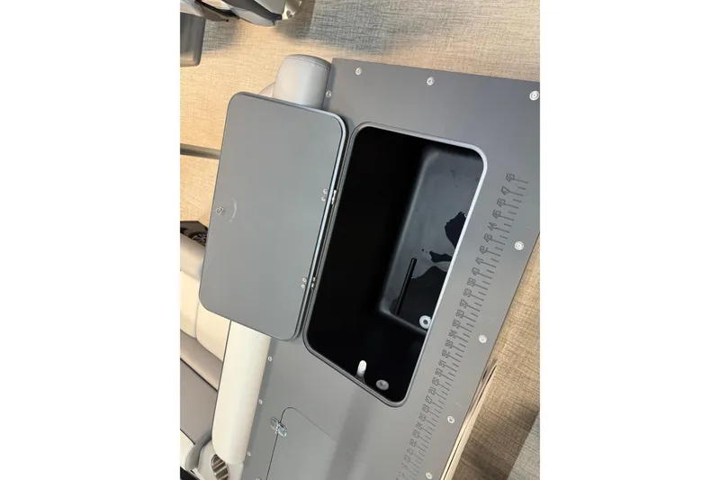 Slide: The Image of 2026 Tahoe Pontoon Sport 85 Rear Fish storage compartment with measuring scale. - 9