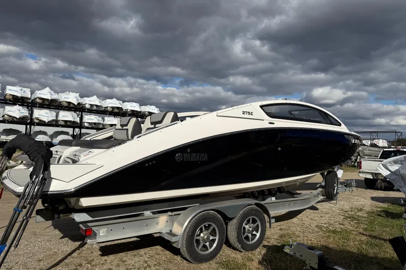 Slide: The Image of 2021 Yamaha Boats 275 E on trailer under cloudy sky. - 1