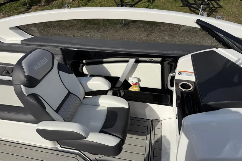 Slide: The Image of 2021 Yamaha Boats 275 E interior with seating and storage compartments. - 10