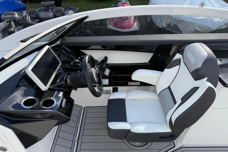 Slide: The Image of 2021 Yamaha Boats 275 E cockpit with modern steering and comfortable seating. - 8