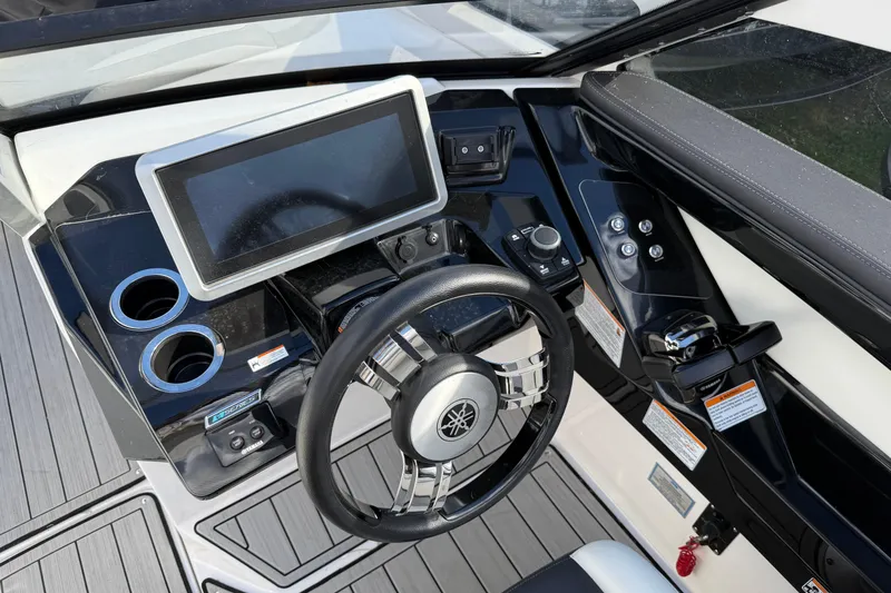 Slide: The Image of Cockpit of 2021 Yamaha Boats 275 E, featuring modern steering and control panel. - 9