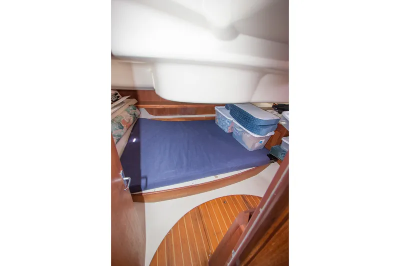 Slide: The Image of Interior cabin of 1997 Hunter 376 sailboat with storage containers on bed. - 12