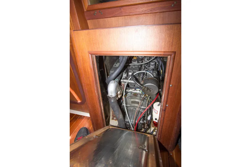 Slide: The Image of Engine compartment of a 1997 Hunter 376 sailboat, showcasing mechanical components and wiring. - 15