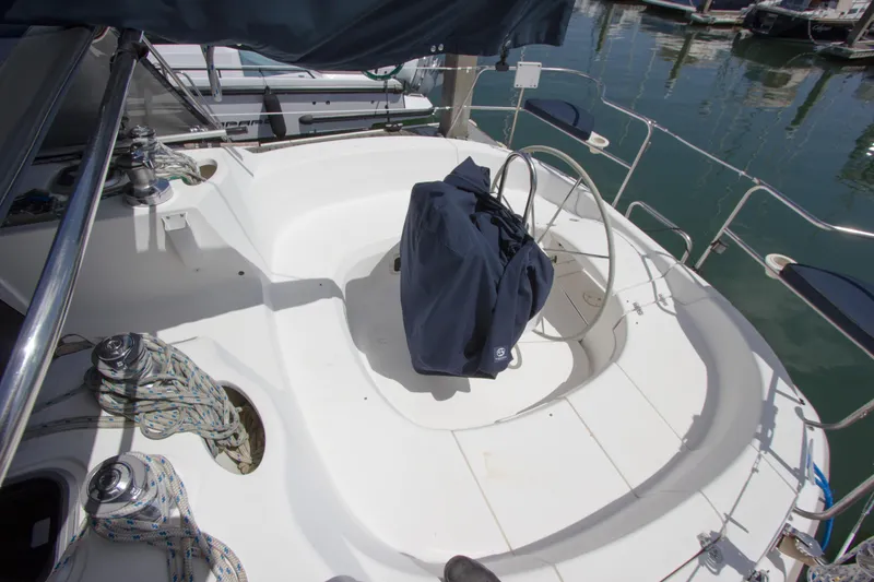 Slide: The Image of Cockpit of a 1997 Hunter 376 sailboat with covered steering wheel and winches. - 16