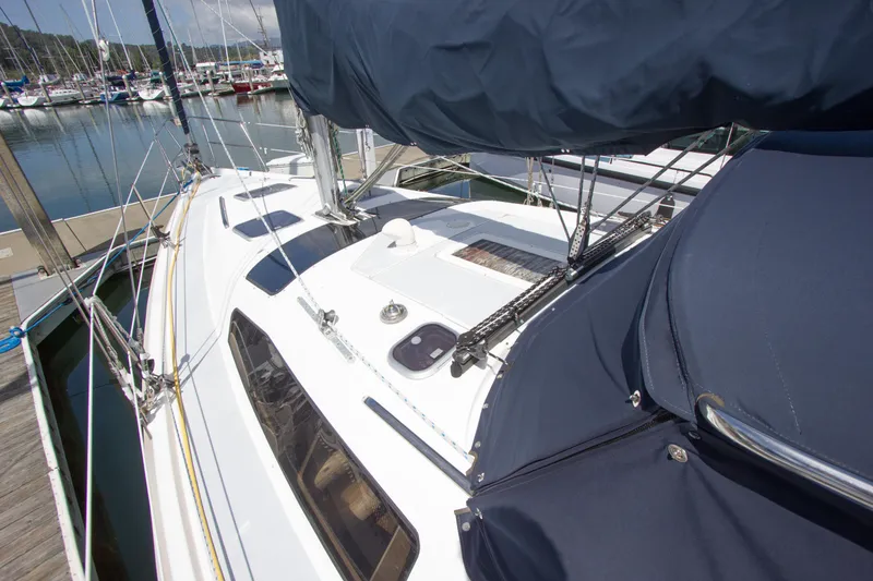 Slide: The Image of 1997 Hunter 376 sailboat docked at marina, featuring sleek design and blue covers. - 19