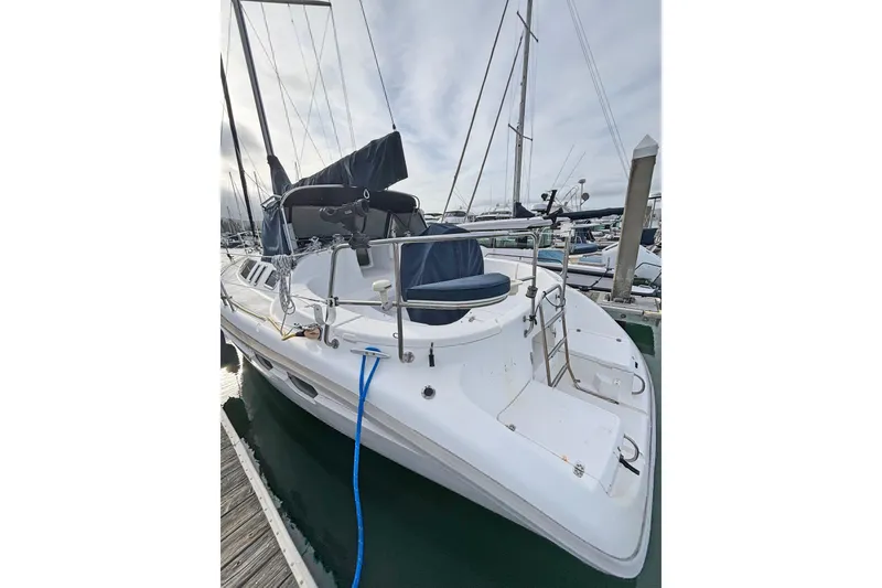 Slide: The Image of 1997 Hunter 376 sailboat docked at marina, featuring sleek design and spacious deck. - 21