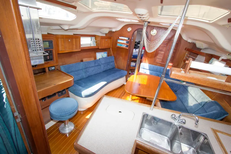 Slide: The Image of Interior of a 1997 Hunter 376 sailboat with cozy seating and wooden finishes. - 4