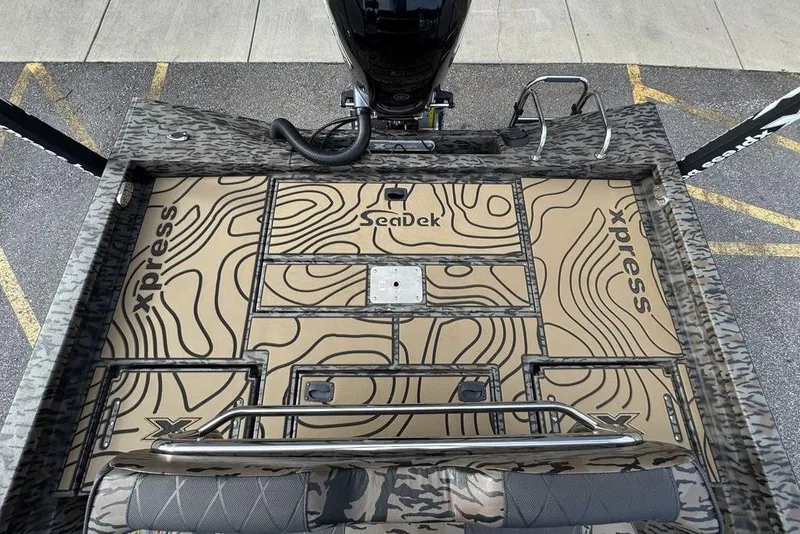 Slide: The Image of 2026 Xpress H22B Bay boat deck with SeaDek flooring and camo design. - 10