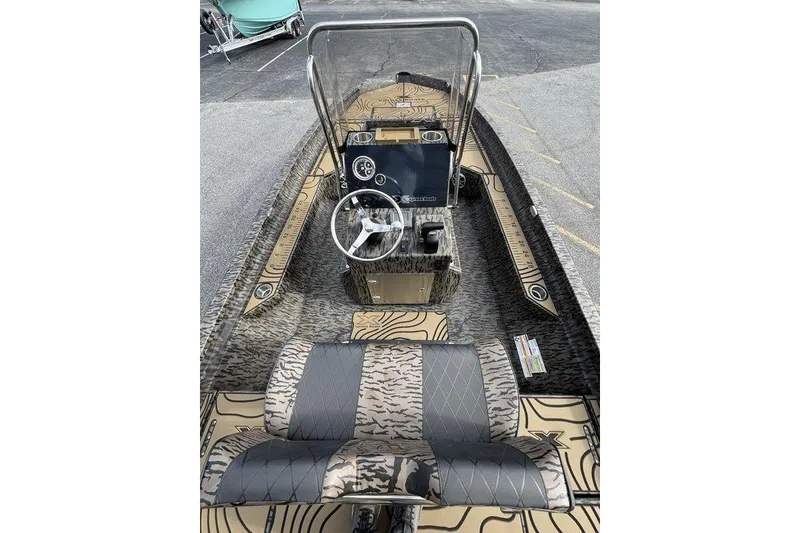 Slide: The Image of 2026 Xpress H22B Bay boat interior with camouflage design and modern steering console. - 11
