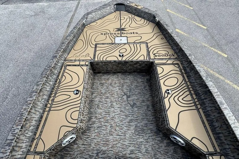 Slide: The Image of 2026 Xpress H22B Bay boat with custom SeaDek flooring and topographic design. - 12