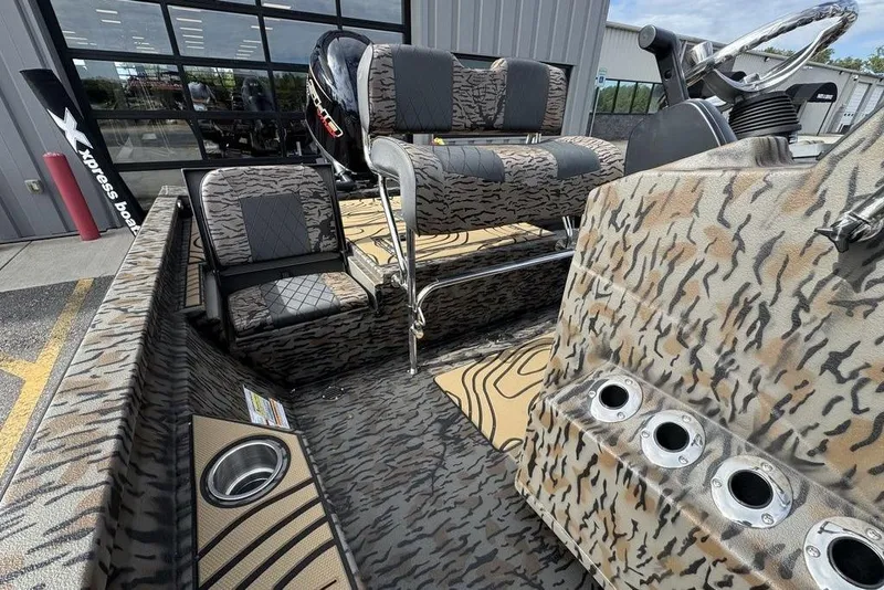 Slide: The Image of 2026 Xpress H22B Bay boat interior with camouflage design and seating. - 16