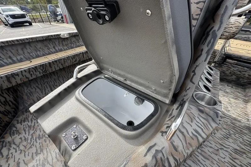 Slide: The Image of 2026 Xpress H22B Bay boat interior with open storage compartment and cup holders. - 18