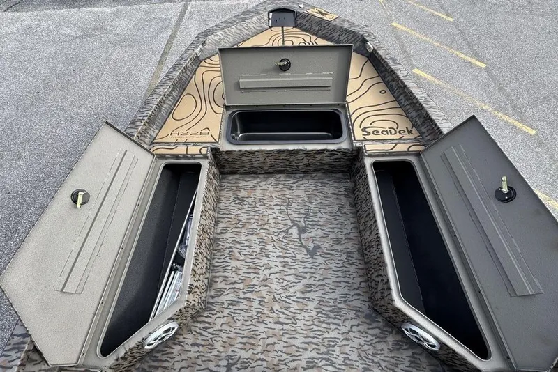 Slide: The Image of 2026 Xpress H22B Bay boat interior with open storage compartments and SeaDek flooring. - 19