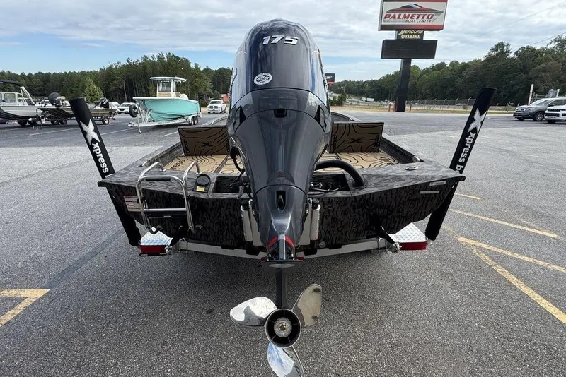 Slide: The Image of 2026 Xpress H22B Bay boat with powerful outboard motor in parking lot. - 3
