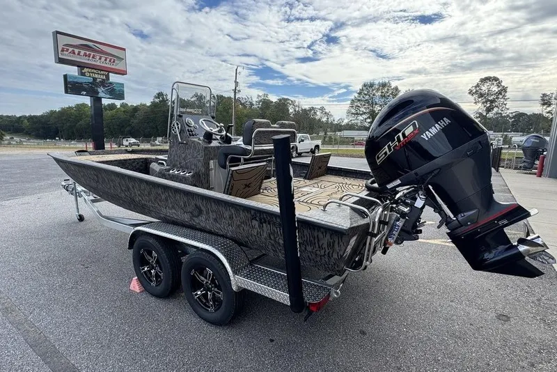 Slide: The Image of 2026 Xpress H22B Bay boat on trailer with Yamaha outboard motor, parked outdoors. - 4