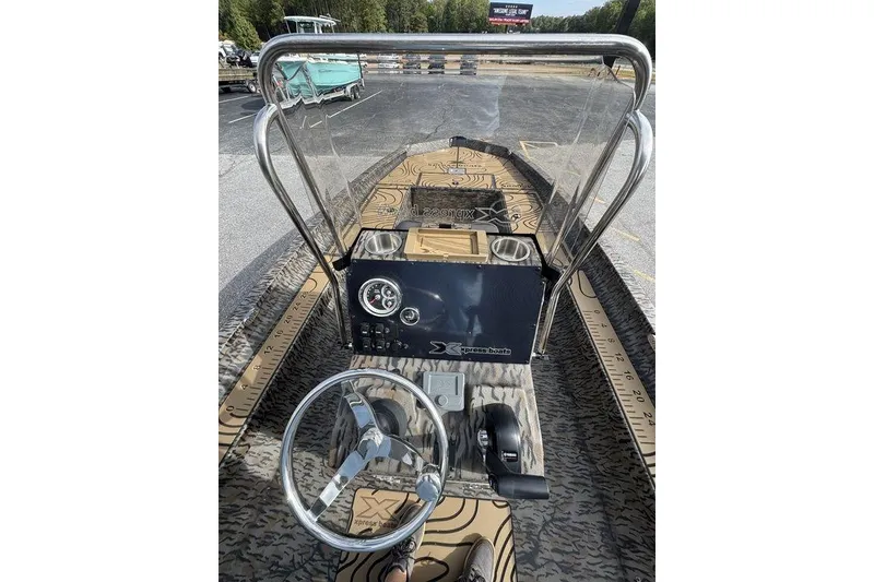 Slide: The Image of 2026 Xpress H22B Bay boat interior with steering wheel and control panel. - 9