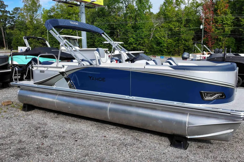 The Image of 2026 Tahoe Pontoon LTZ Quad Lounger, blue and silver, displayed outdoors. - 1