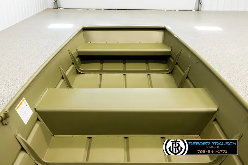 Slide: The Image of 2025 Lund 1240 boat interior with bench seats, displayed in a showroom. - 12