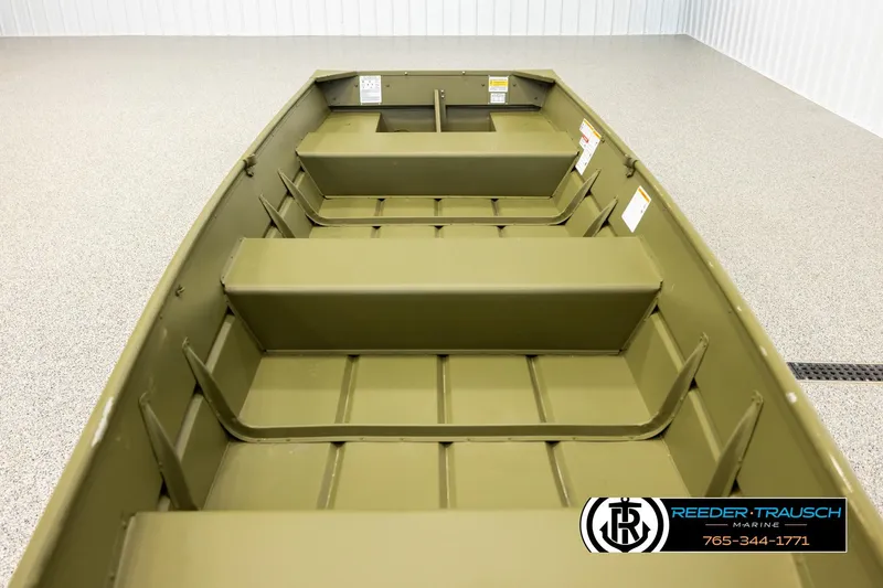 Slide: The Image of 2025 Lund 1240 boat interior with bench seats, displayed in a showroom. - 14