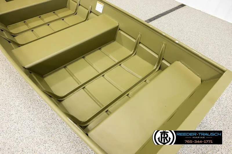 Slide: The Image of 2025 Lund 1240 boat interior with seating, displayed on a showroom floor. - 7