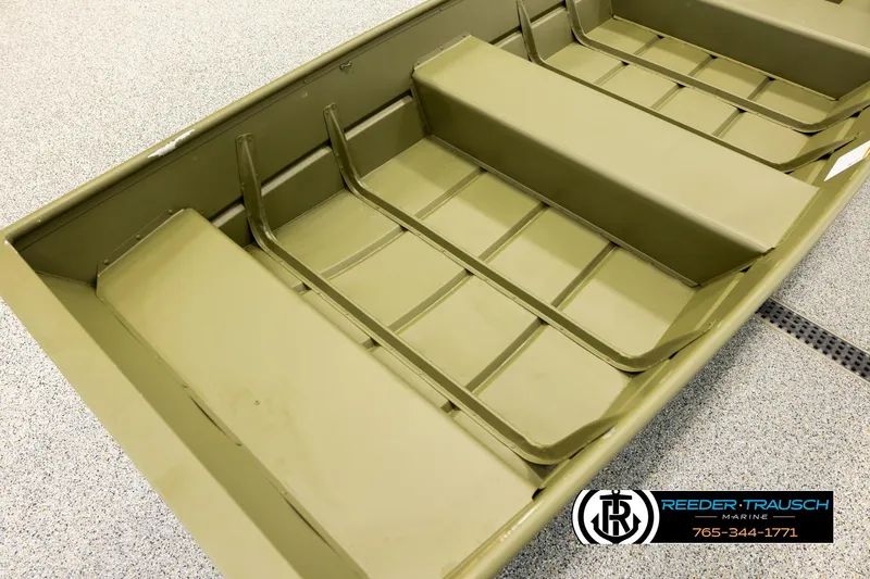 Slide: The Image of 2025 Lund 1240 boat interior with bench seats, displayed at Reeder-Trausch Marine showroom. - 8