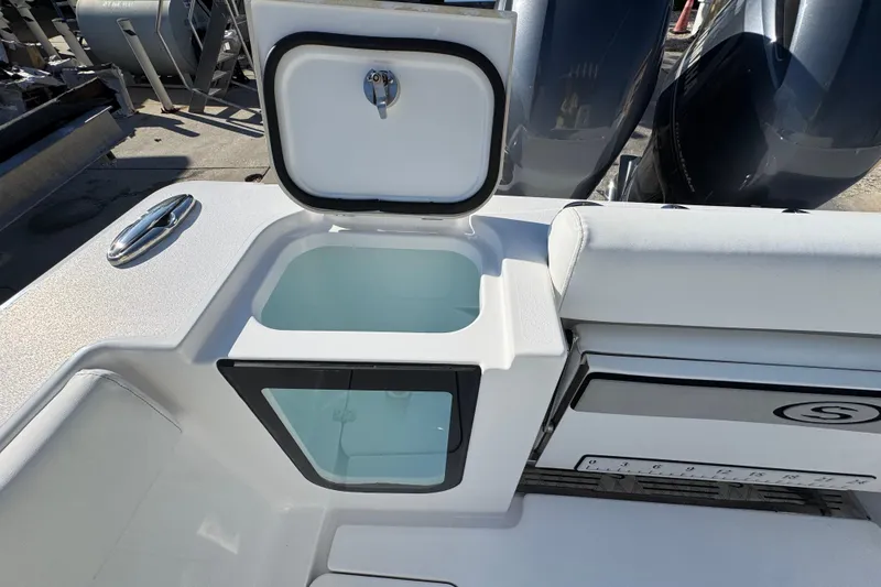 Slide: The Image of 2022 Sportsman Open 232 Center Console boat with open storage compartment. - 10