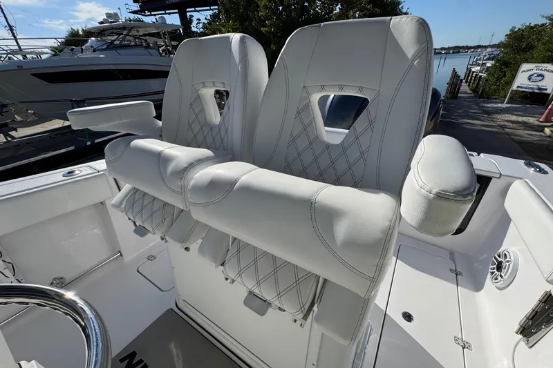 Slide: The Image of 2022 Sportsman Open 232 Center Console boat with white cushioned seating. - 13