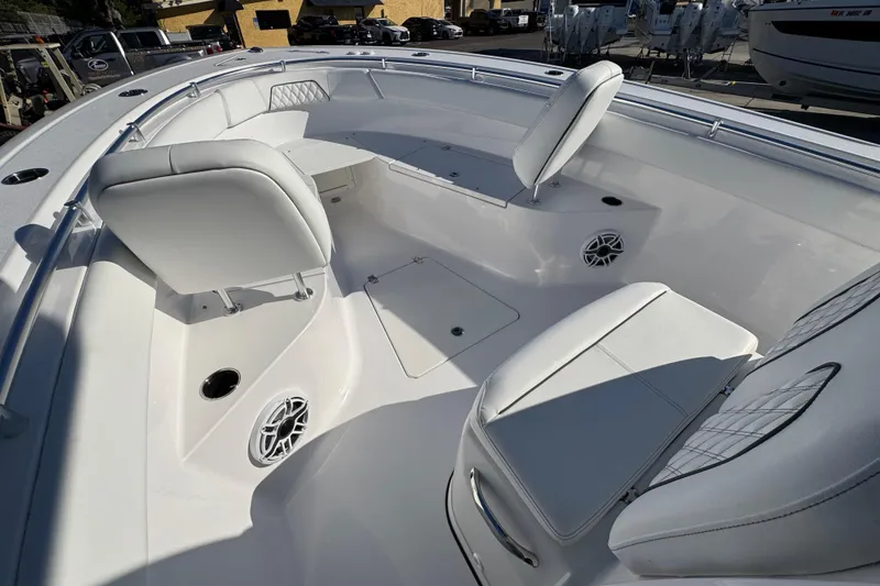 Slide: The Image of 2022 Sportsman Open 232 Center Console boat interior with white seating and speakers. - 16