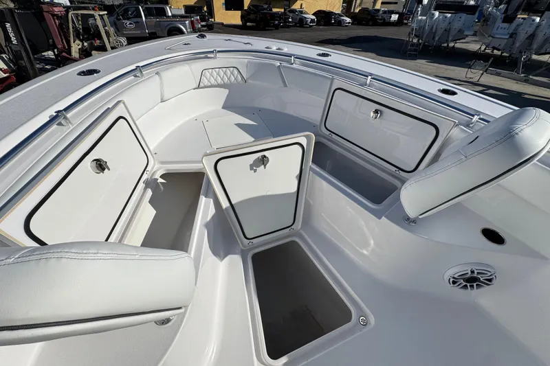 Slide: The Image of 2022 Sportsman Open 232 Center Console boat interior with open storage compartments. - 17