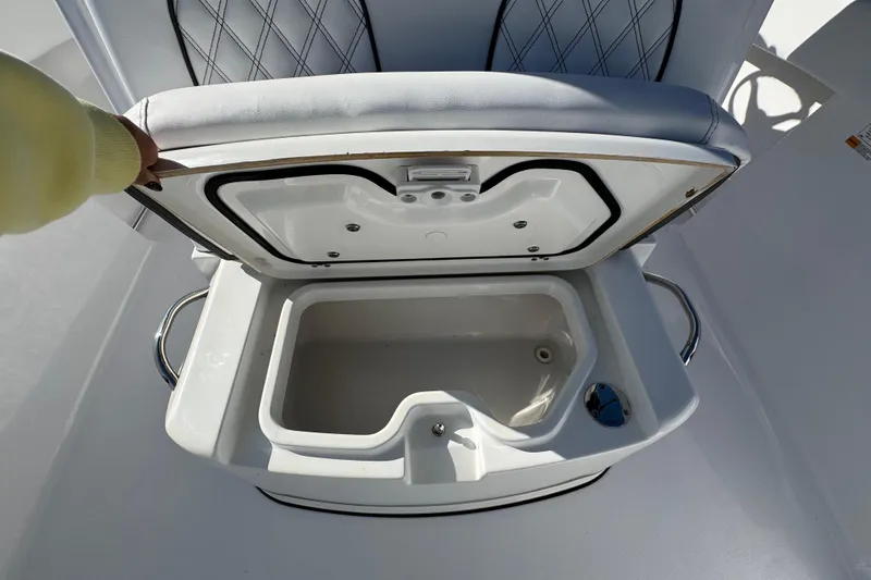 Slide: The Image of Open storage compartment on 2022 Sportsman Open 232 Center Console boat. - 19
