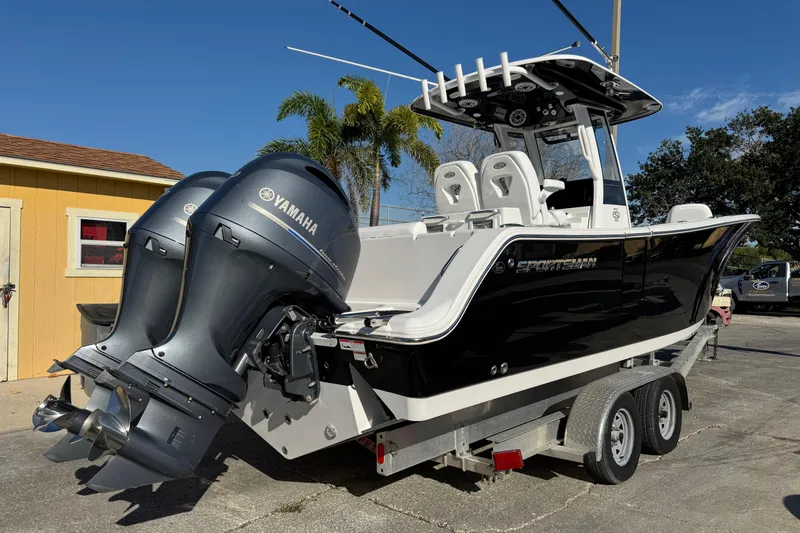 Slide: The Image of 2022 Sportsman Open 232 Center Console boat with dual Yamaha engines on a trailer. - 2