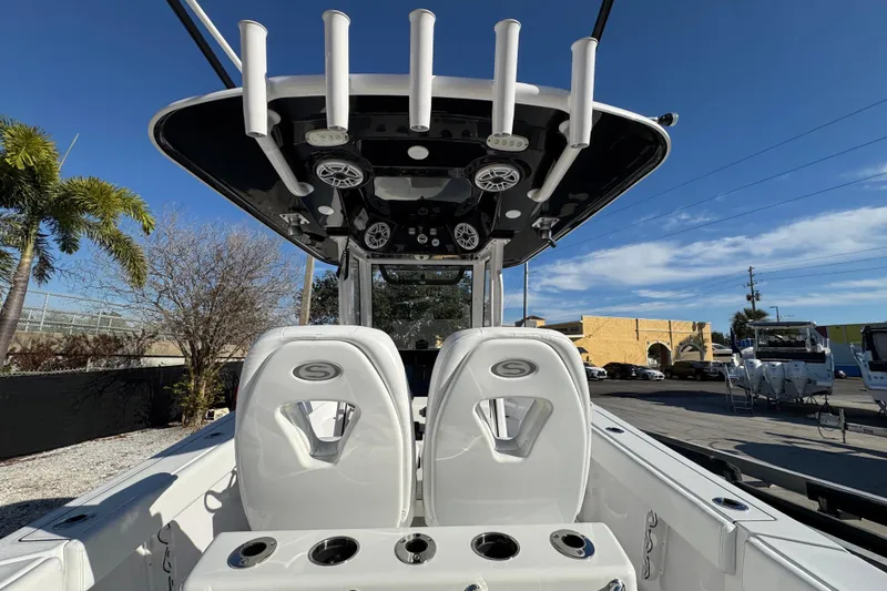 Slide: The Image of 2022 Sportsman Open 232 Center Console boat interior with rod holders and seating. - 7