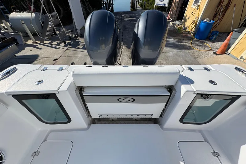 Slide: The Image of 2022 Sportsman Open 232 Center Console boat with dual engines at dock. - 8