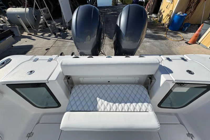 Slide: The Image of 2022 Sportsman Open 232 Center Console boat with dual engines and cushioned seating. - 9