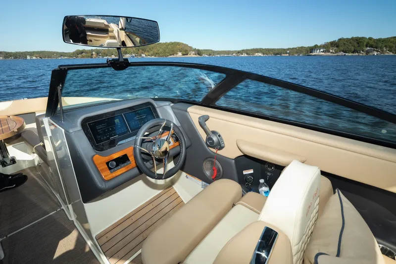 Slide: The Image of Interior of 2026 Chris-Craft Sportster 28 boat with modern dashboard and steering wheel. - 24