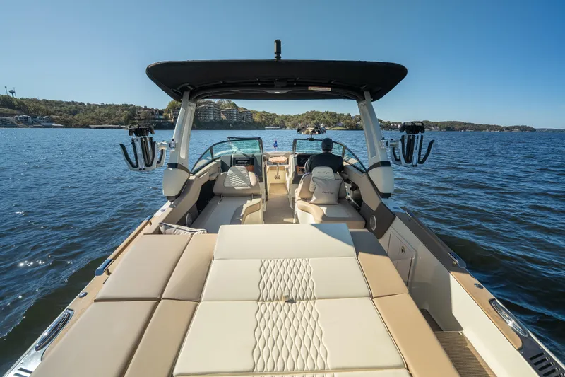 Slide: The Image of 2026 Chris-Craft Sportster 28 on a serene lake, showcasing luxury seating and sleek design. - 25