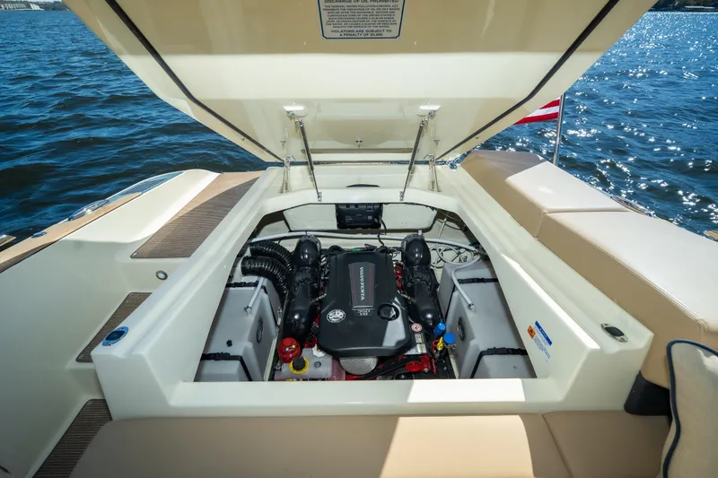 Slide: The Image of 2026 Chris-Craft Sportster 28 engine compartment open, showcasing powerful marine engine. - 28