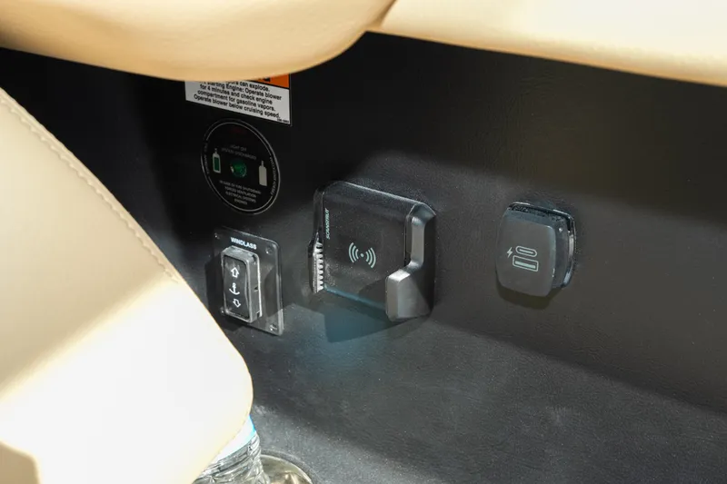 Slide: The Image of Control panel of 2026 Chris-Craft Sportster 28 with wireless charging and windlass switch. - 29