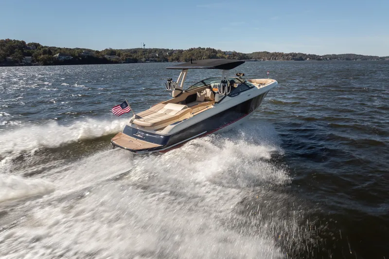 Slide: The Image of 2026 Chris-Craft Sportster 28 cruising on a lake, showcasing sleek design and performance. - 32